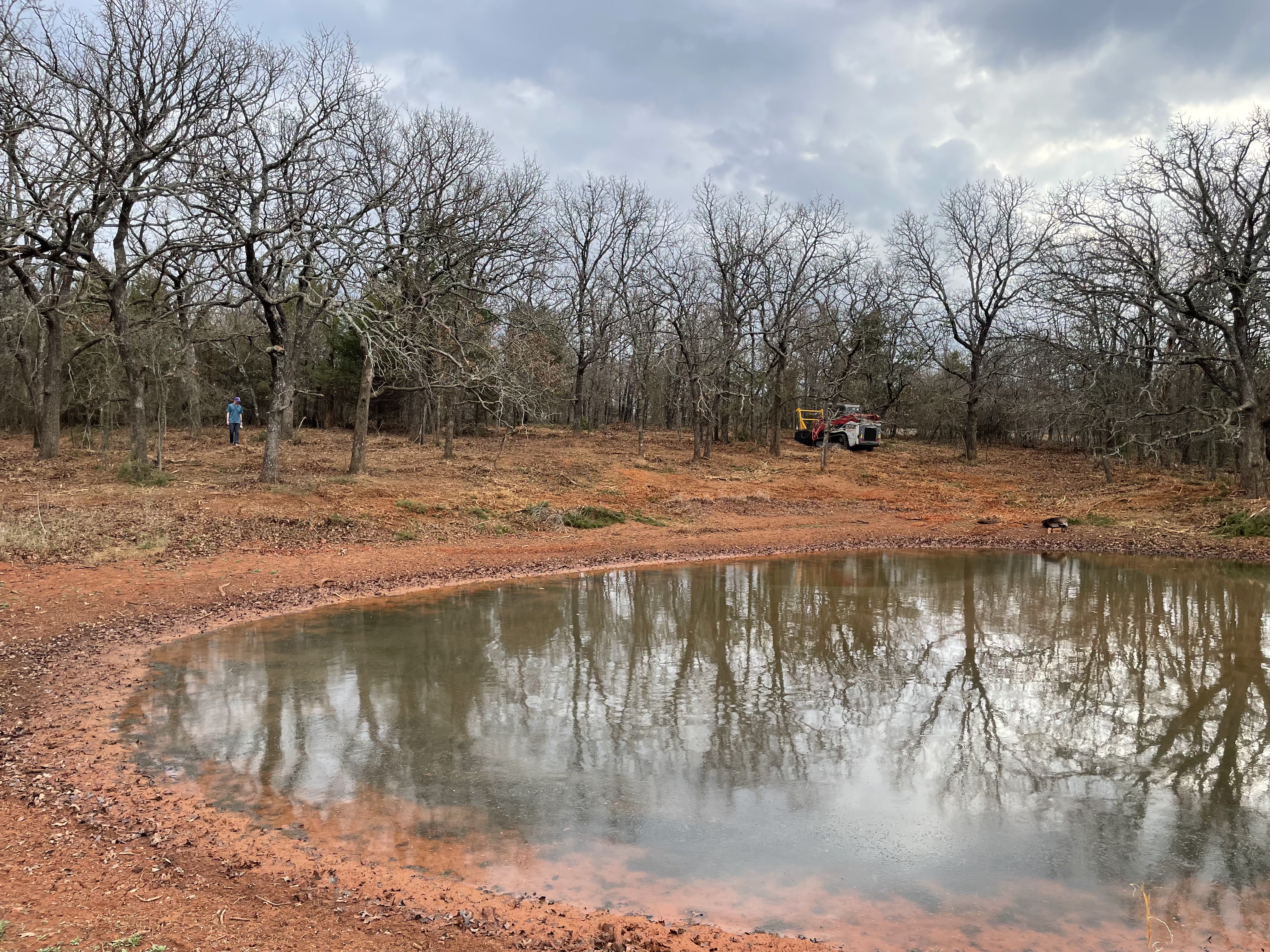 After: Pond area cleared of cedar and brush with native oaks preserved by Oklahoma Mulch Works